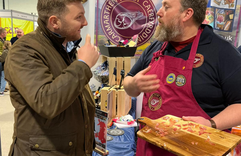 Samuel Kurtz MS at the Carmarthen Ham stand at the Royal Welsh Winter Fair 2023