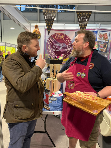 Samuel Kurtz MS at the Carmarthen Ham stand at the Royal Welsh Winter Fair 2023